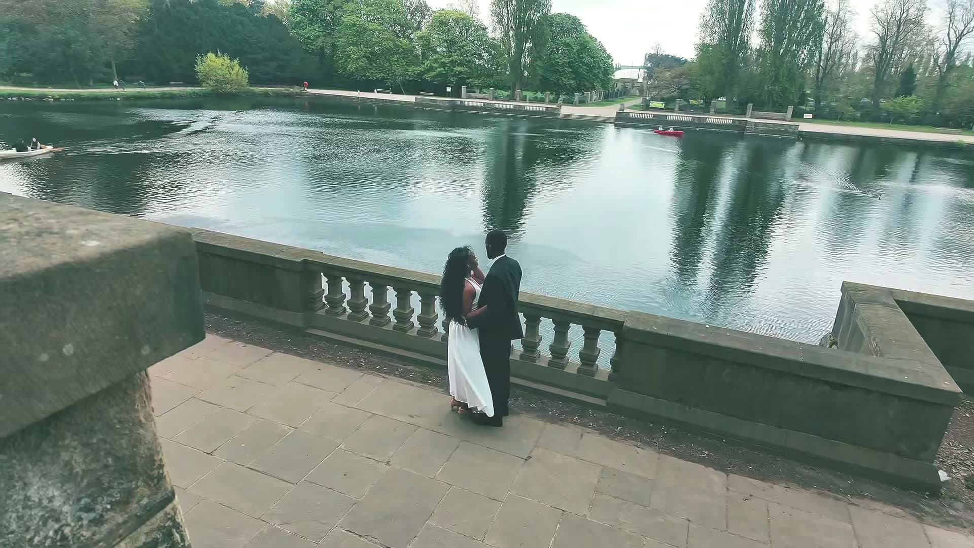 A couple standing together in a stone colonnade at a pre-wedding shoot